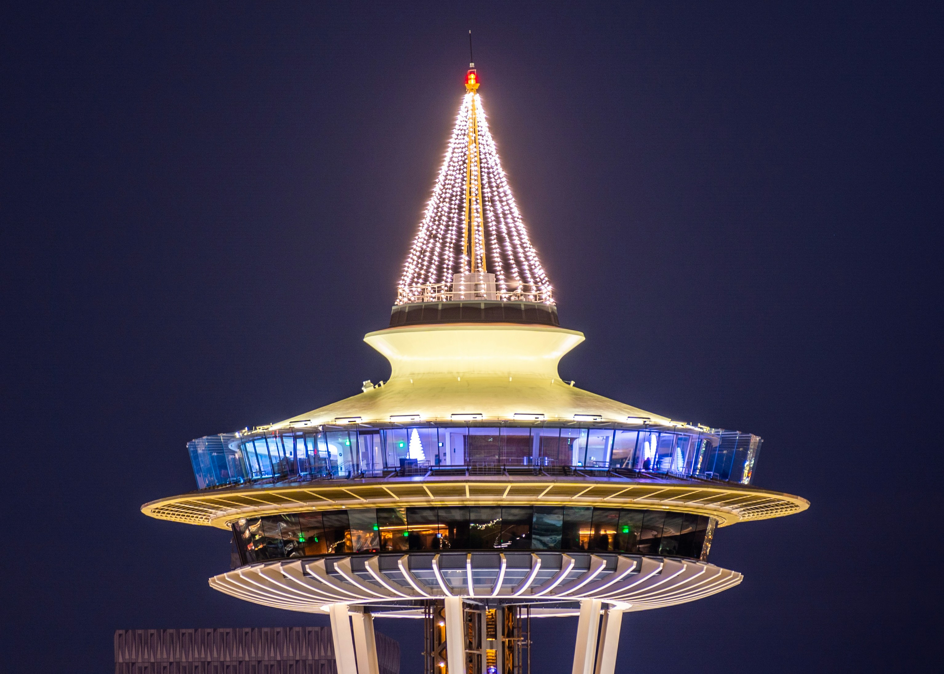 a tall tower with a lit up christmas tree on top