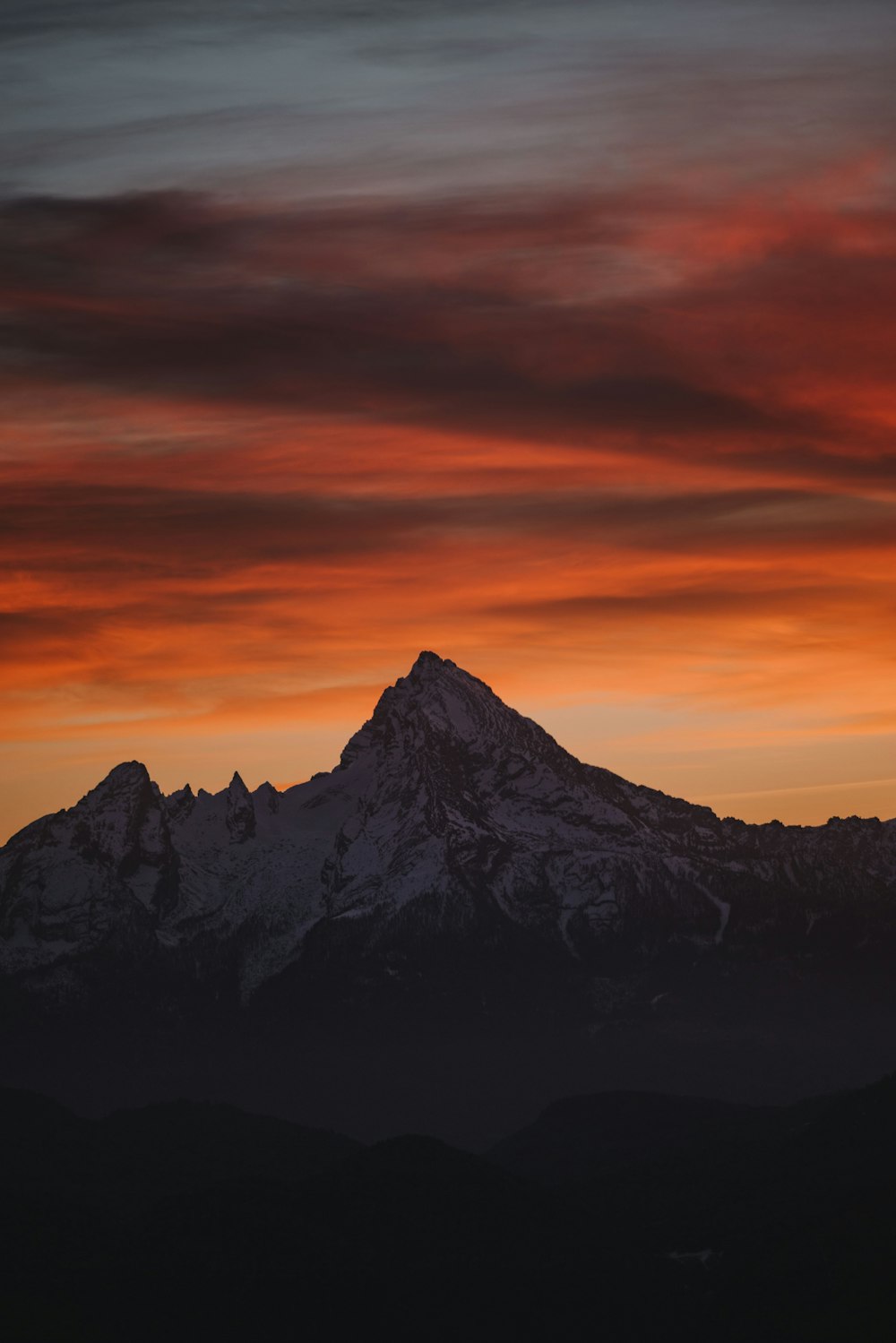 a mountain with a red sky in the background