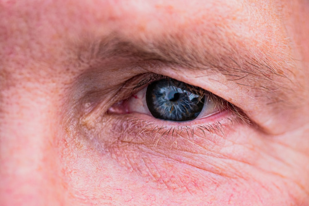 a close up of a man's blue eye