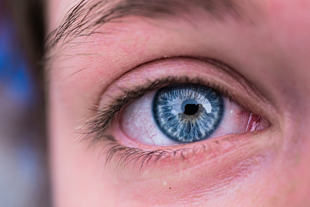 a close up of a person's blue eye