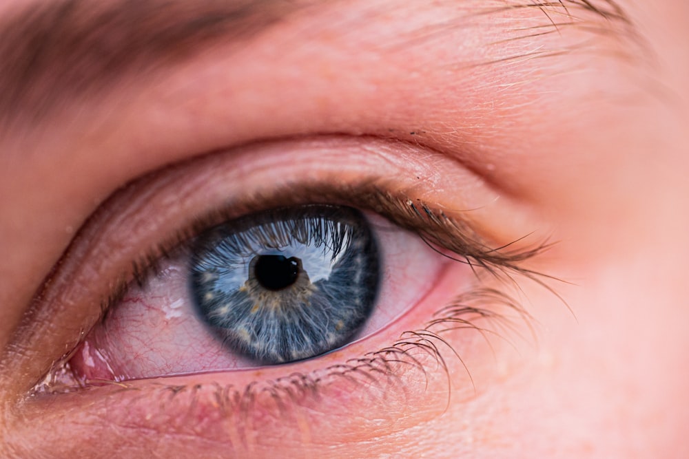 a close up of a person's blue eye