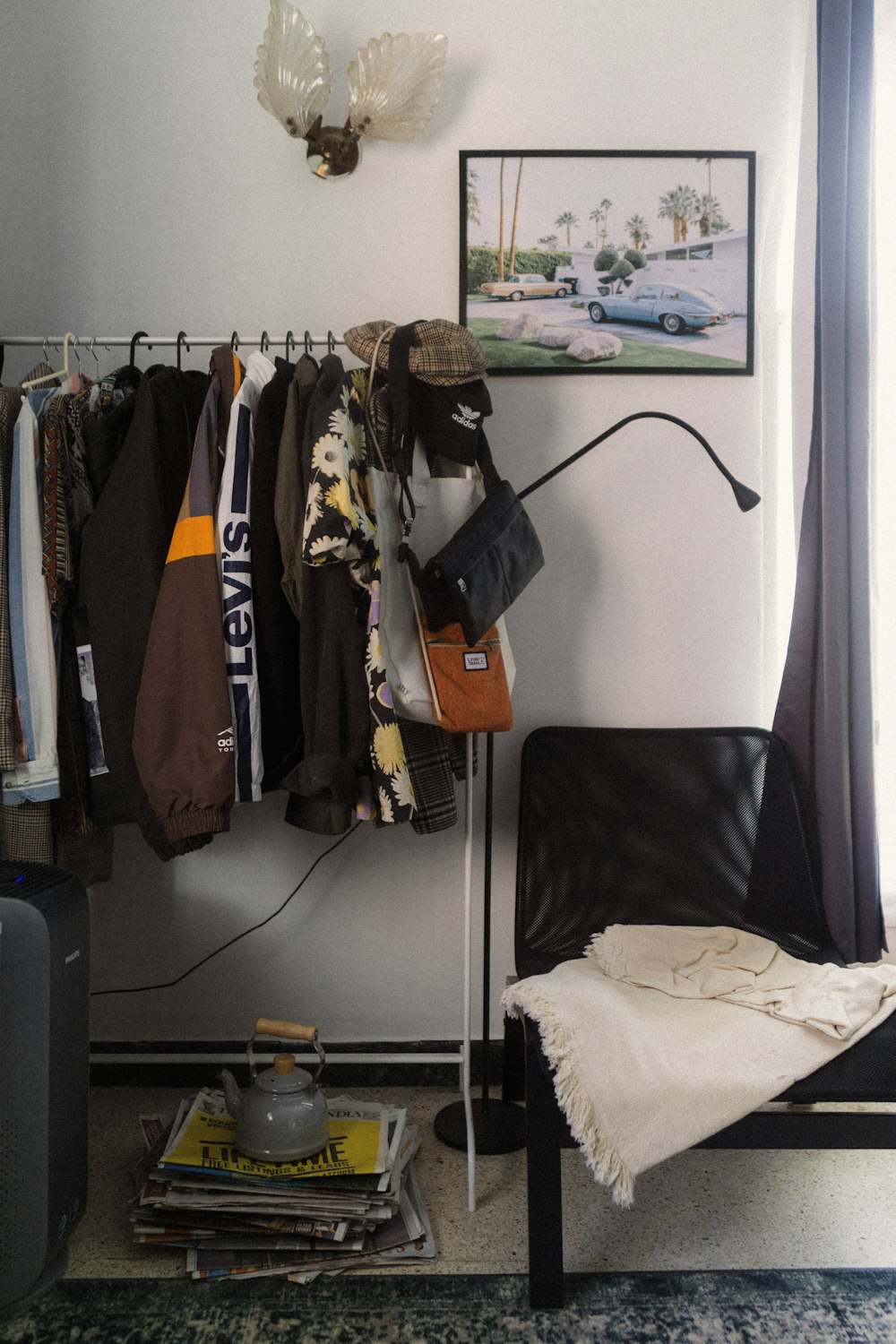 a room with clothes hanging on a rack