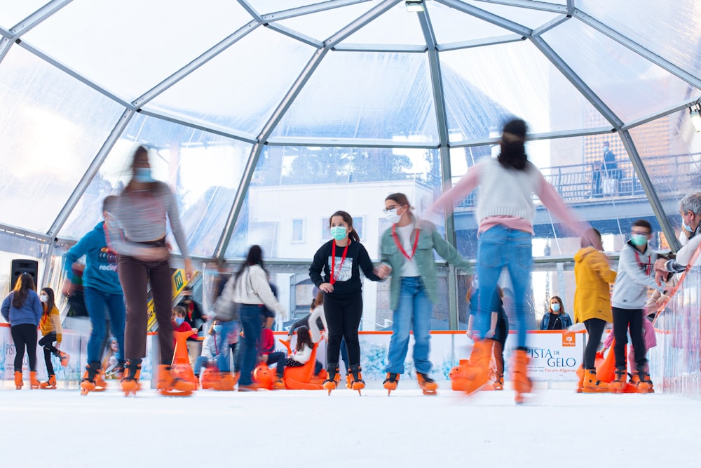 a group of people riding roller skates on a snowy surface