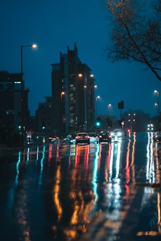 a city street filled with lots of traffic at night