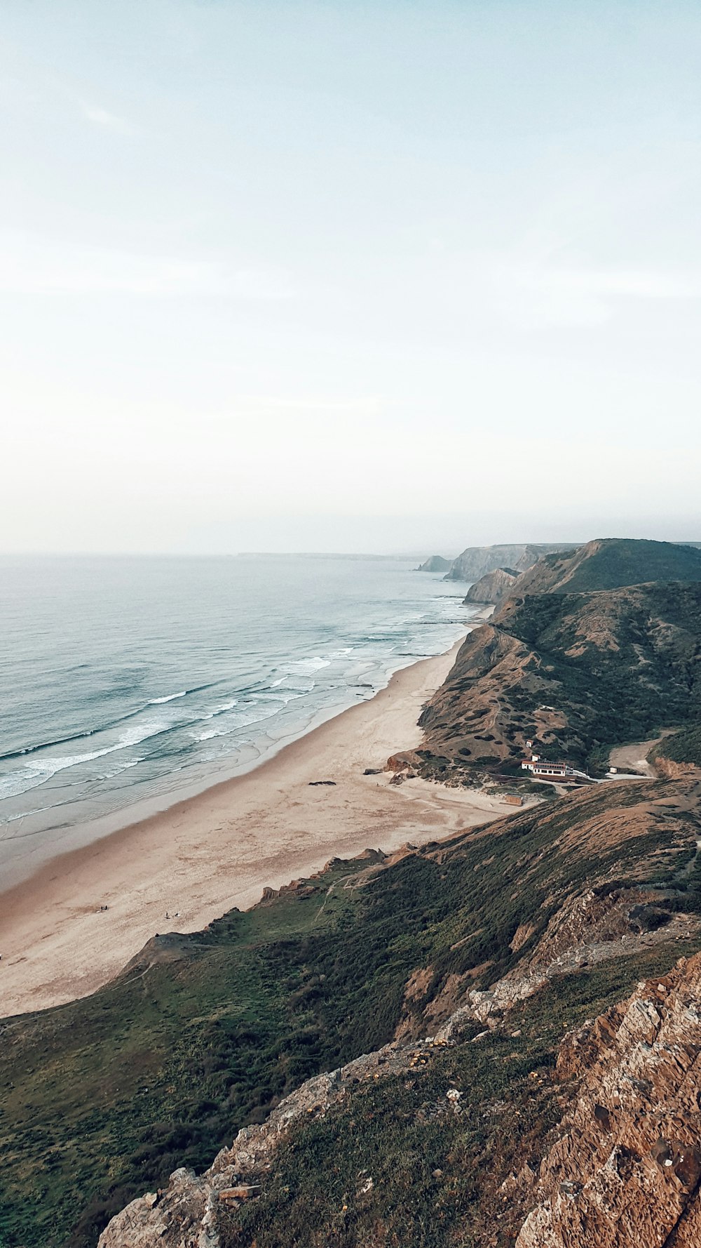 a view of a beach from a cliff