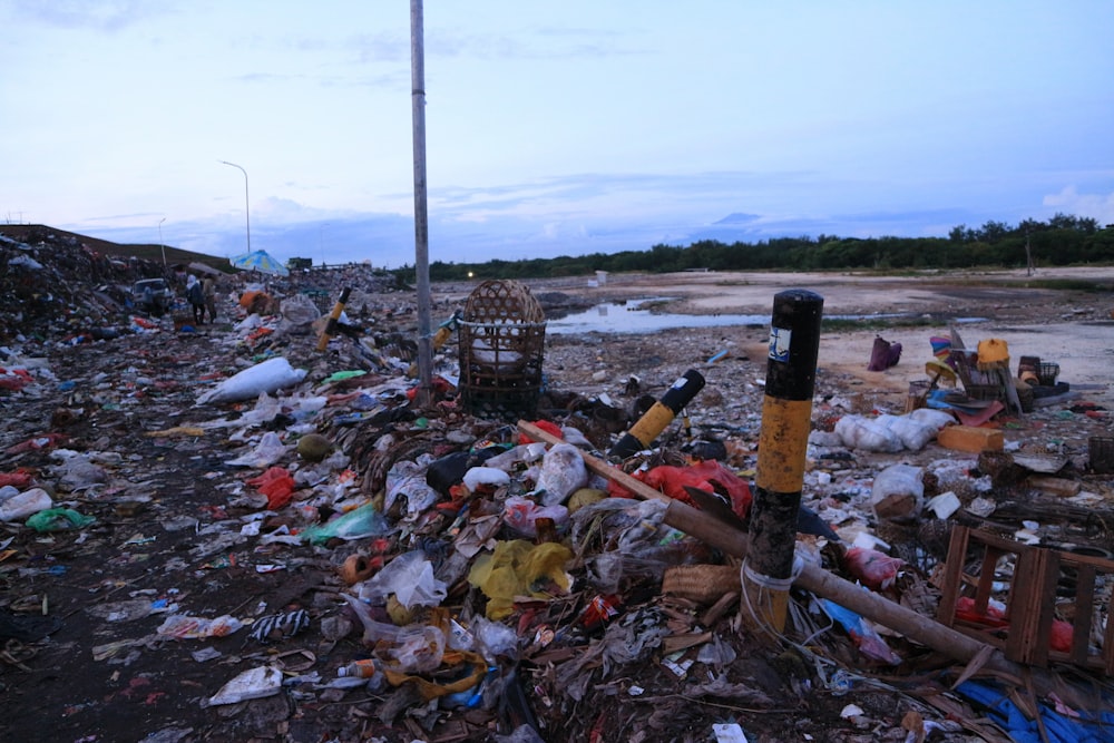 a pile of trash sitting on top of a dirt field