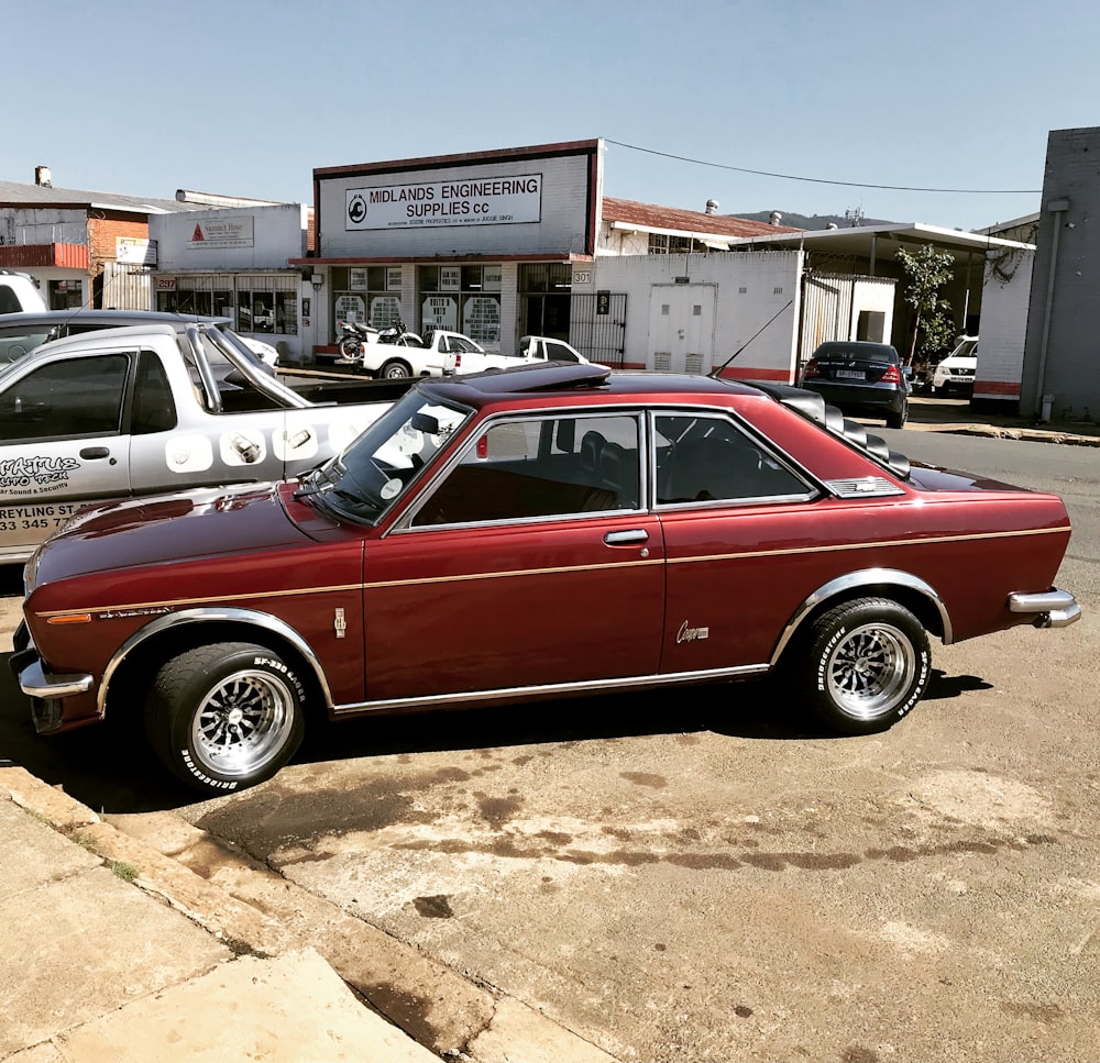 a red car is parked in a parking lot