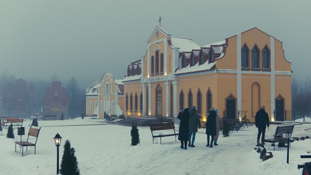 a group of people standing in front of a church