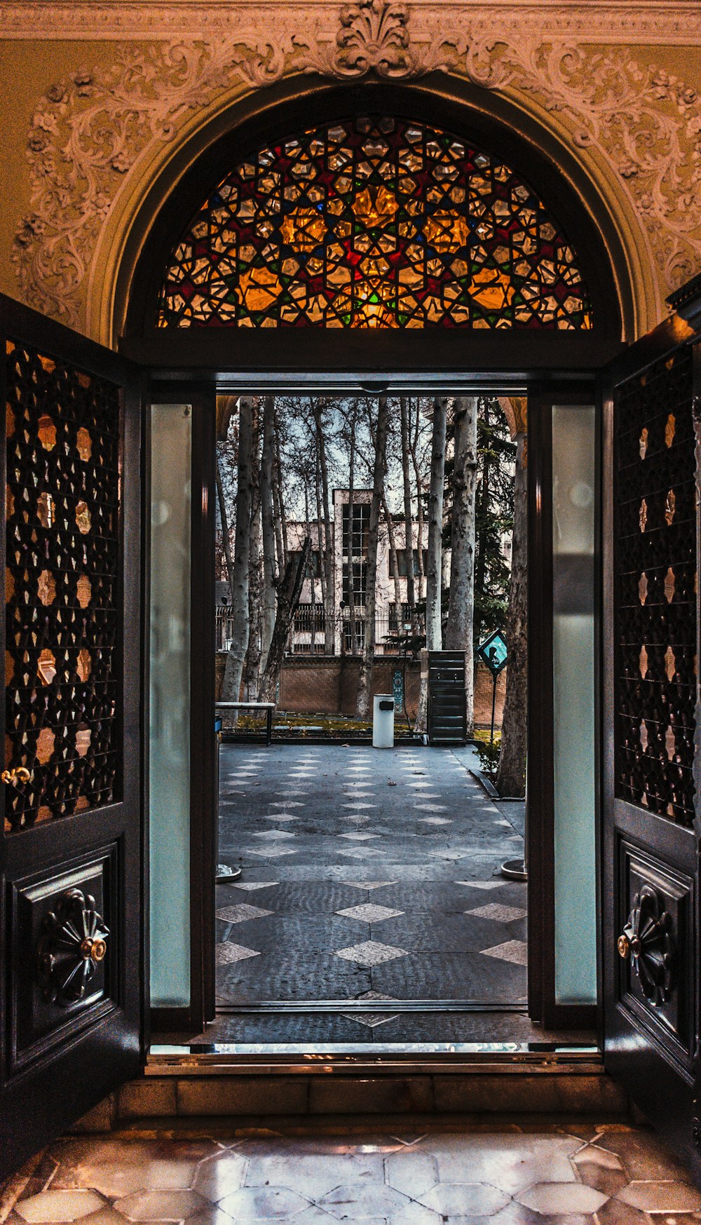 an open door leading to a building with a clock tower in the background