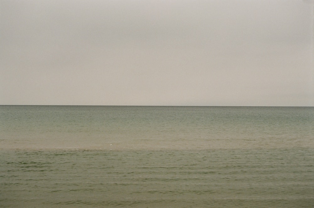 a large body of water sitting under a cloudy sky