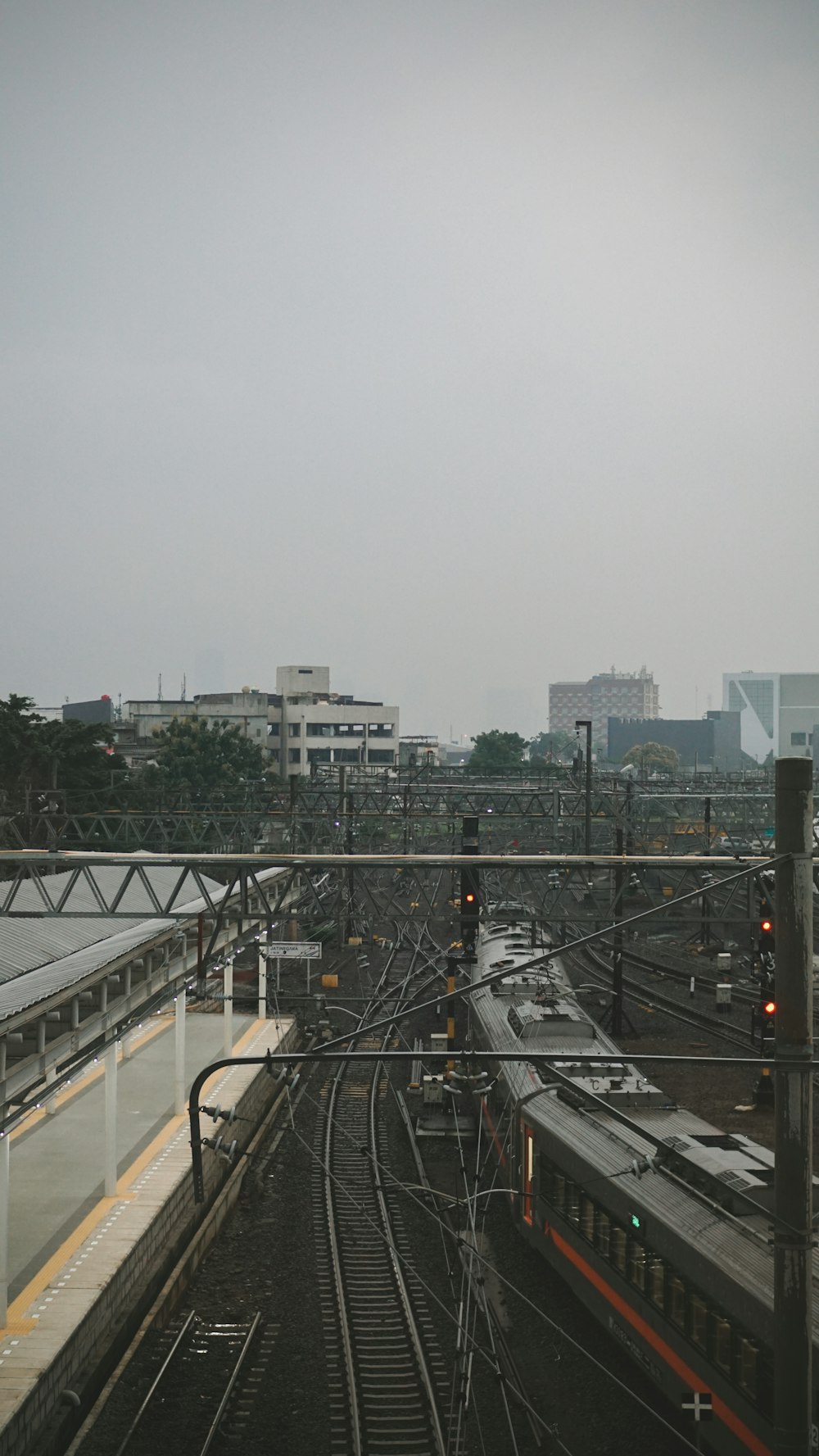 a train traveling down train tracks next to a train station