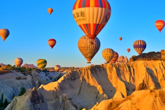 a group of hot air balloons flying in the sky