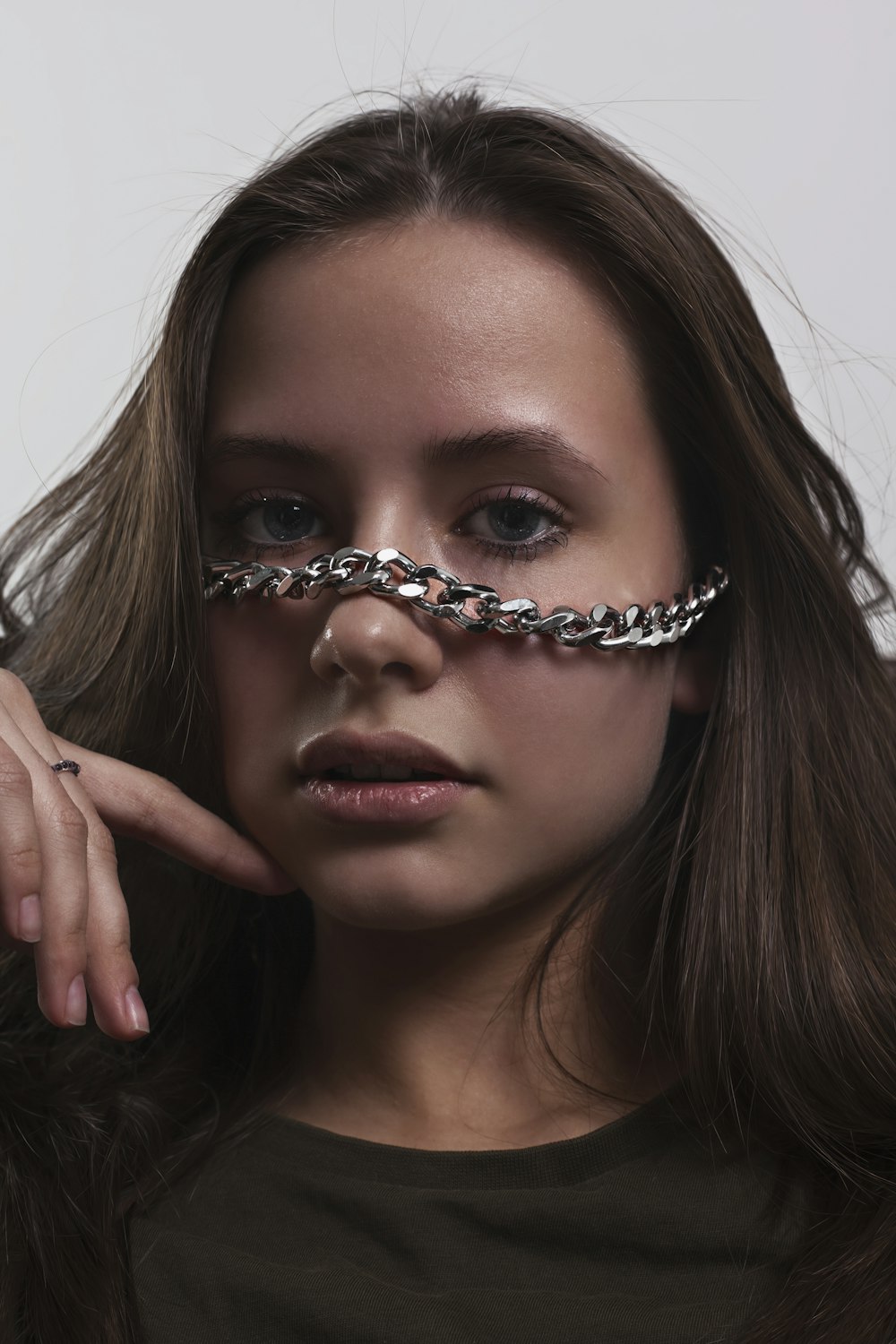 a woman with a chain around her face