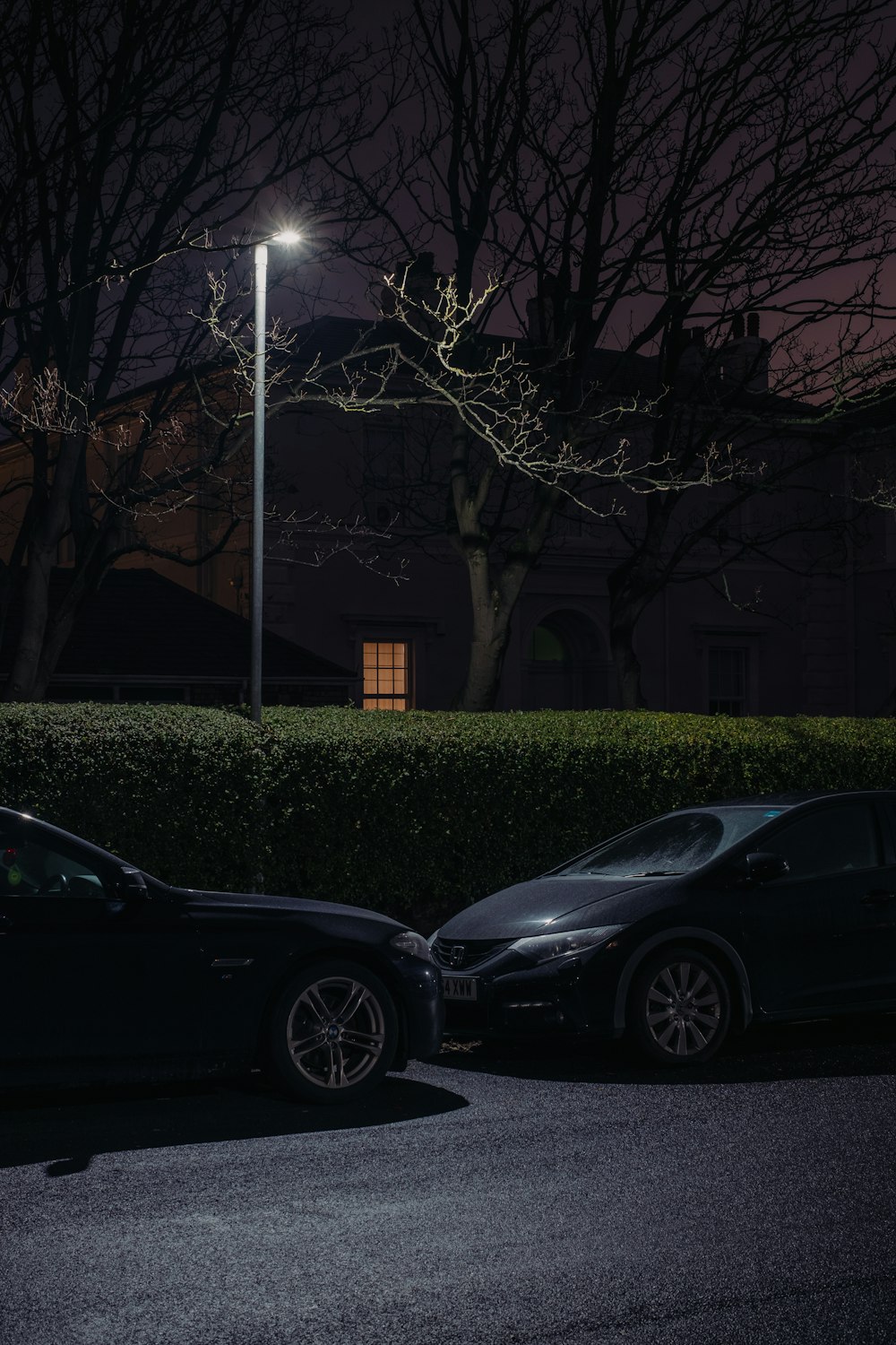 two cars parked next to each other in a parking lot