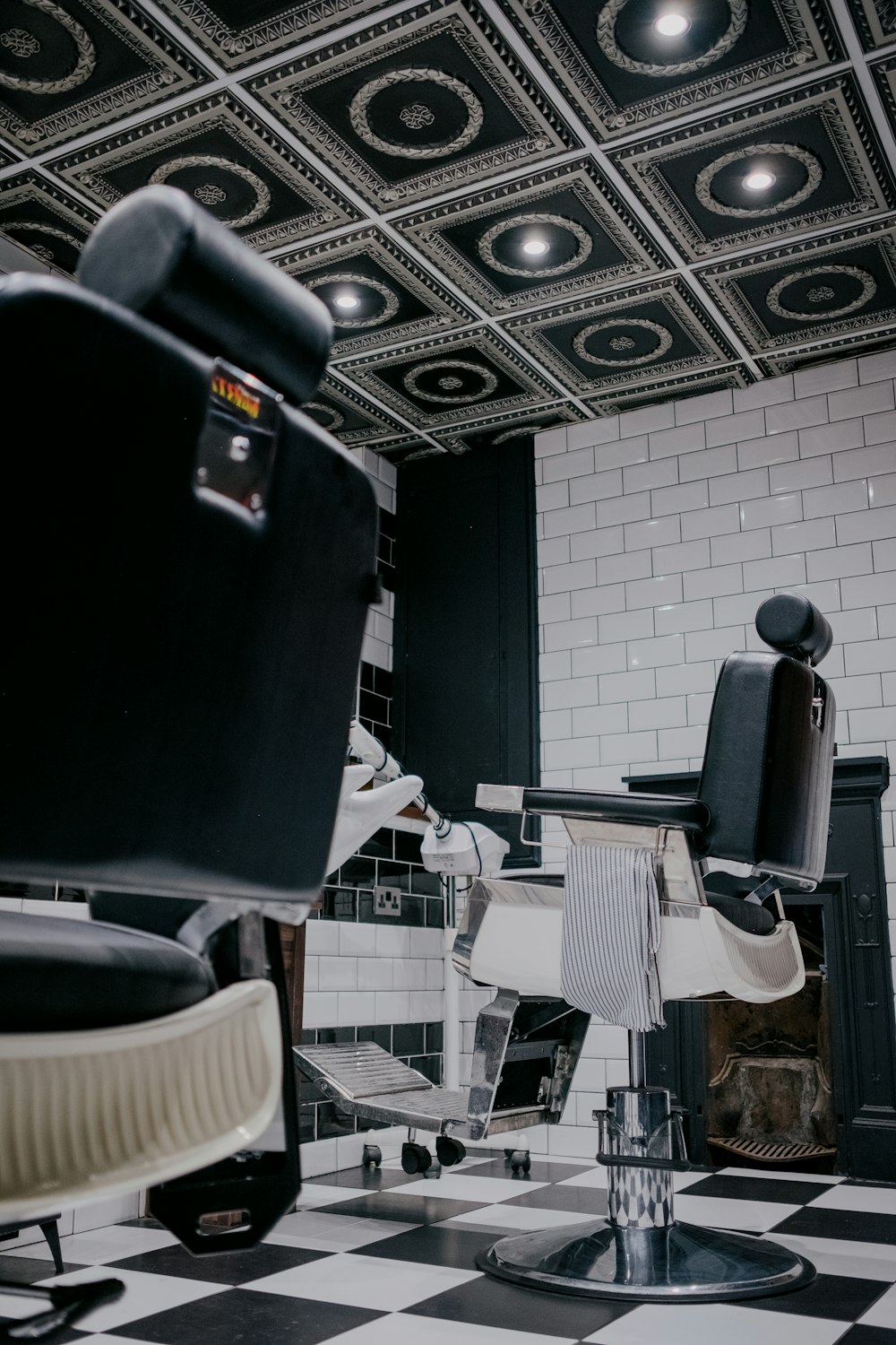 a barber shop with a checkered floor and black and white tile