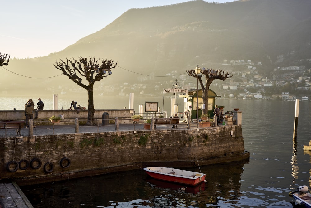 a small boat is docked at a pier