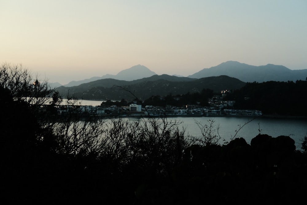 a body of water with mountains in the background