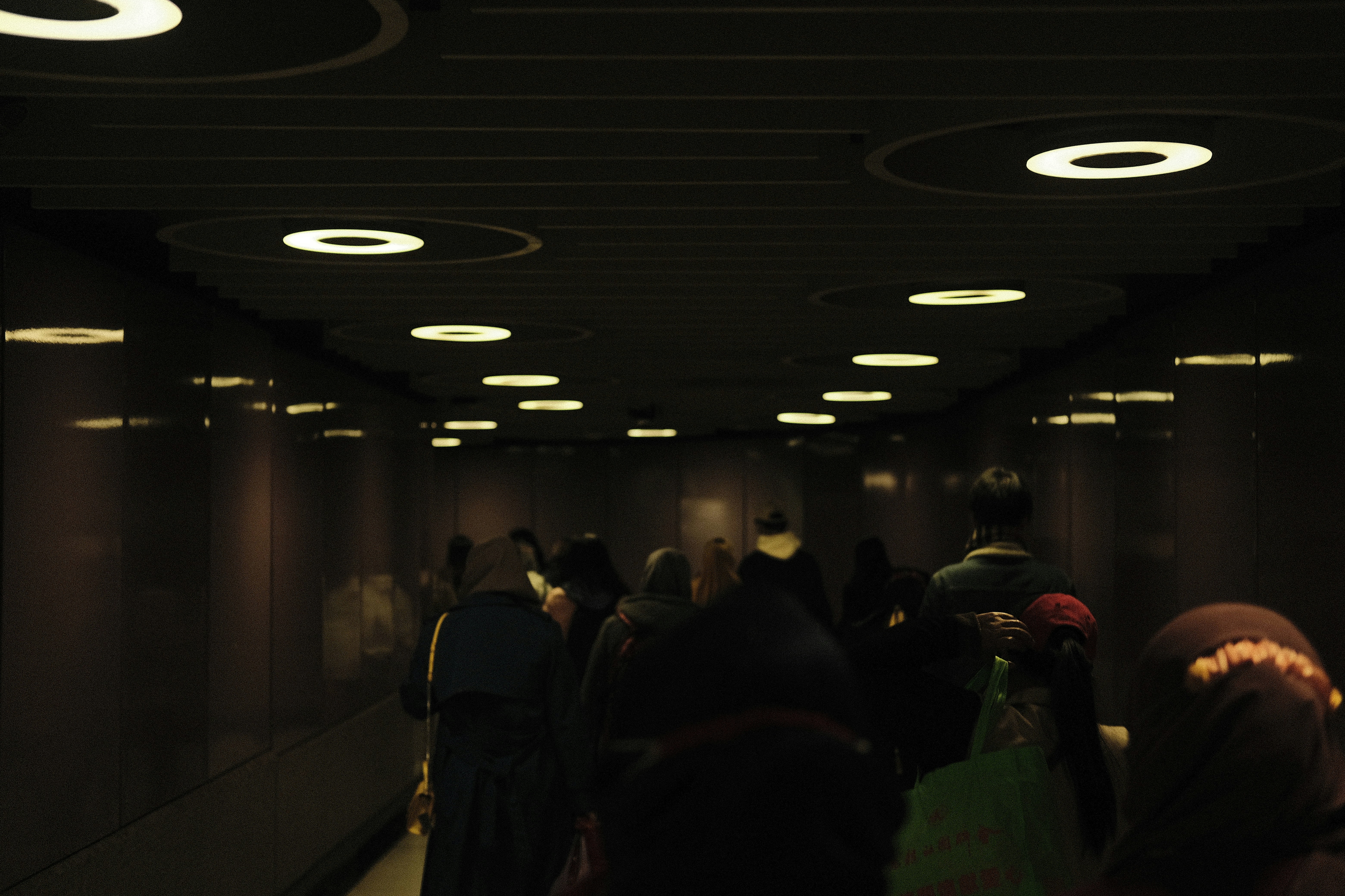 a group of people walking down a hallway