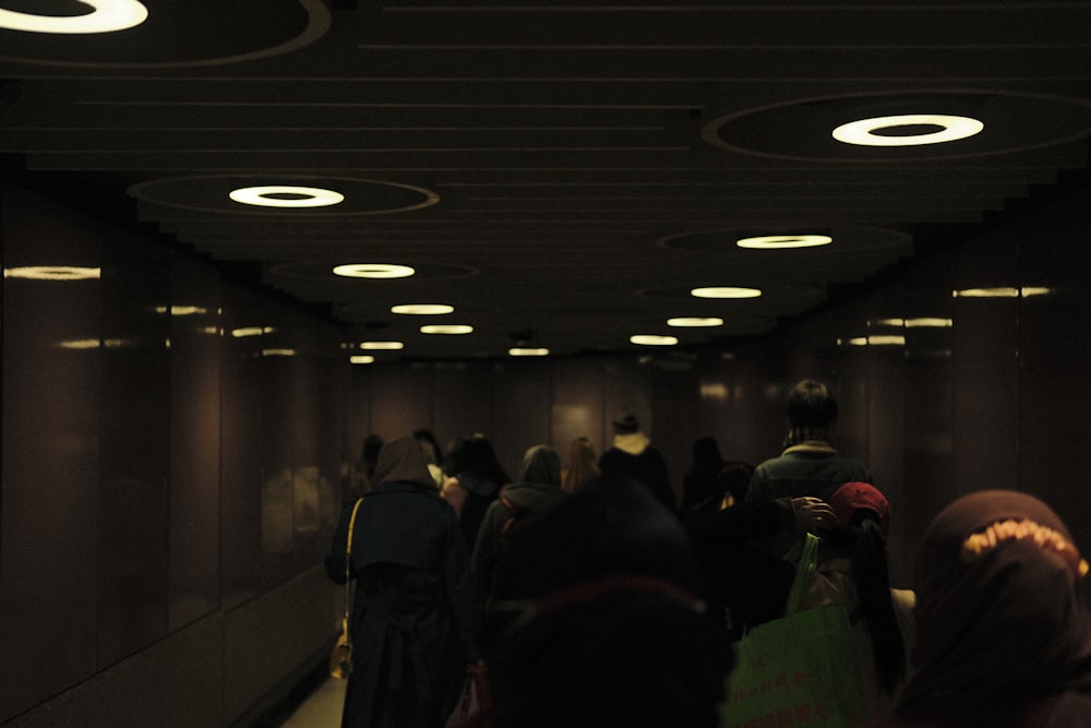 a group of people walking down a hallway