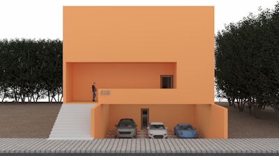 Modern gray and black townhouse with orange accents and a garage.