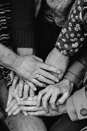 a group of people holding hands together