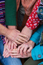 a group of people stacking their hands together