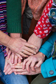 a group of people stacking their hands together