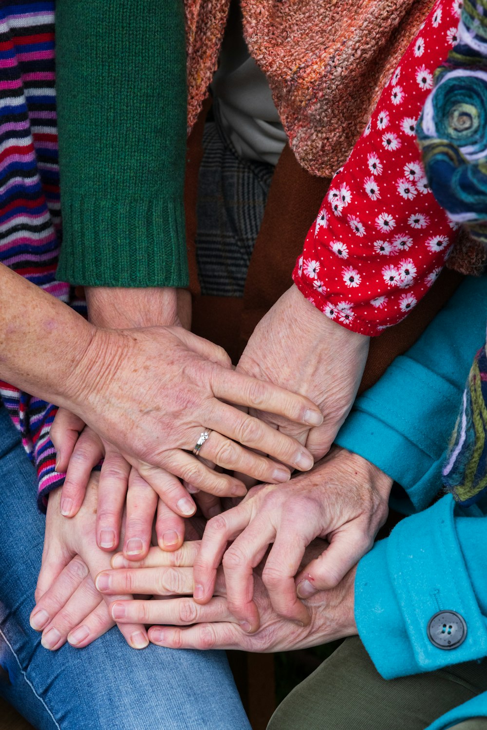 a group of people stacking their hands together