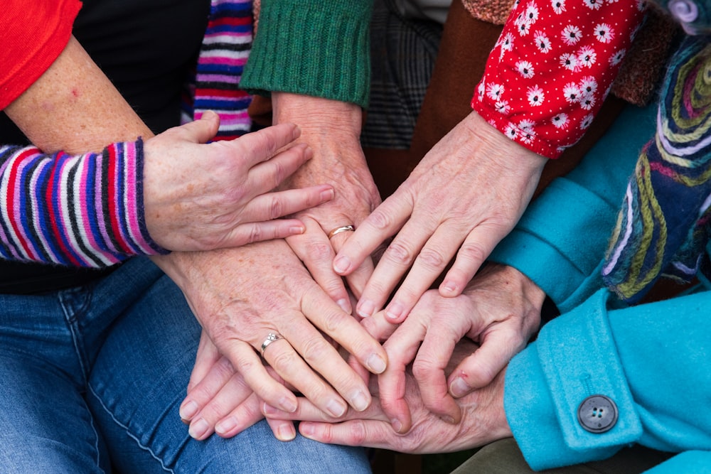 a group of people with their hands together