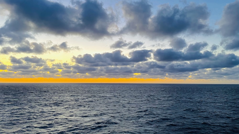 a large body of water under a cloudy sky