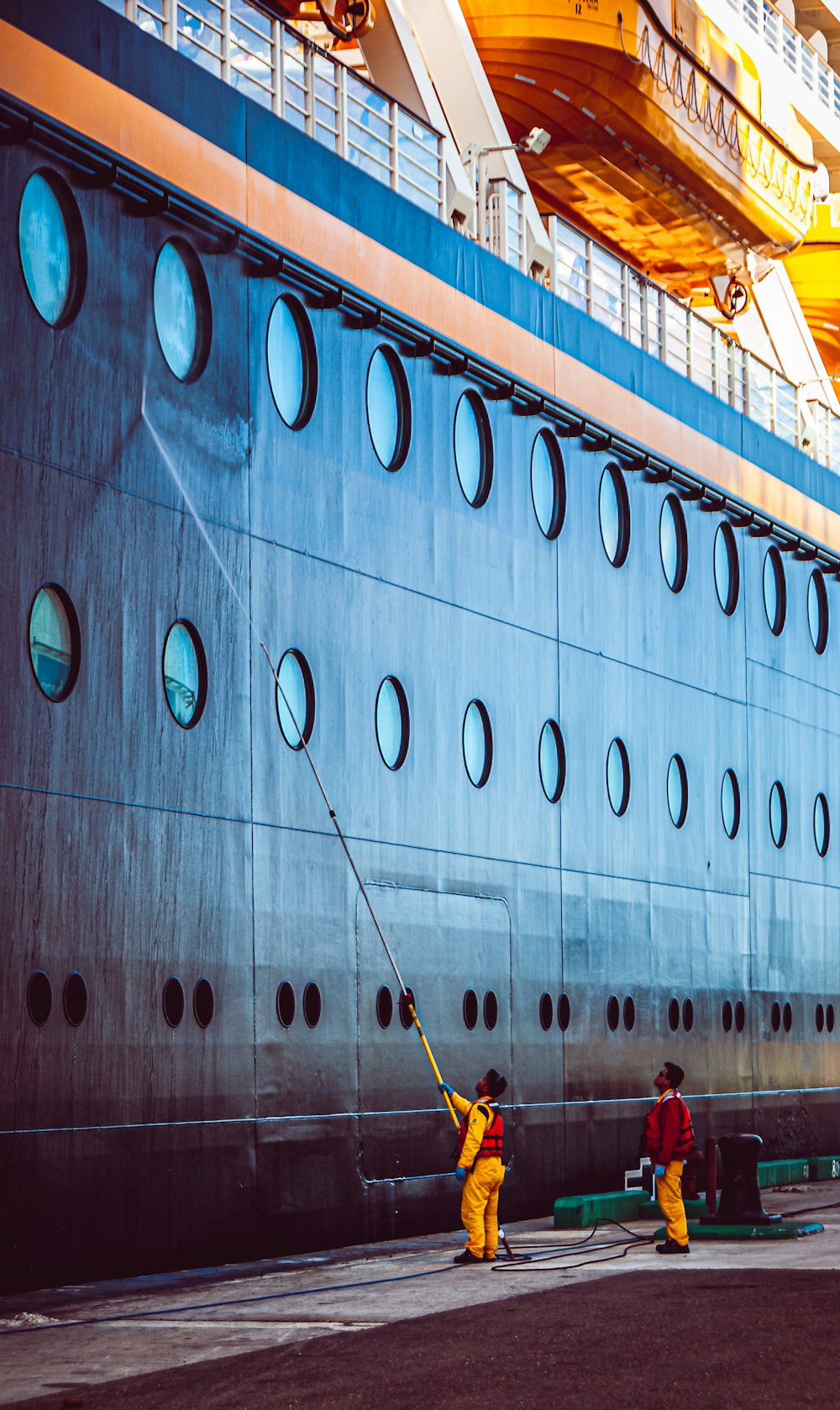 a couple of people are cleaning a cruise ship