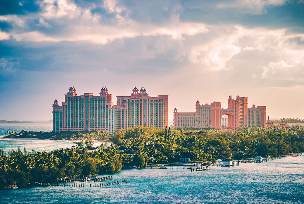 a view of a resort and a body of water