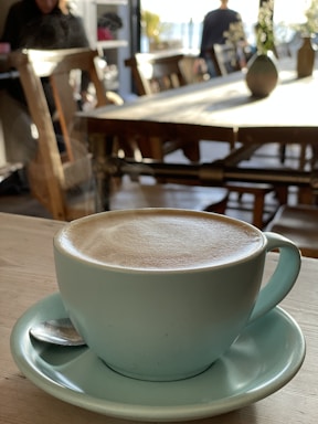 Close-up of a specialty coffee cup on a wooden table inside ritorno.