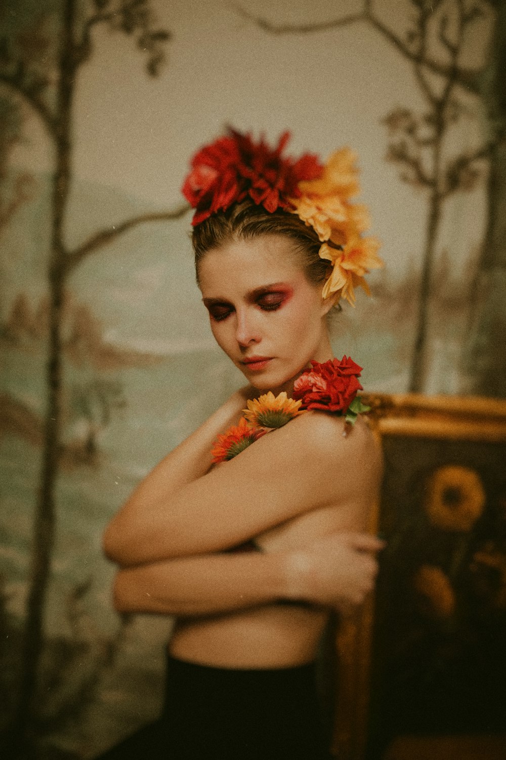 a woman with flowers in her hair posing for a picture