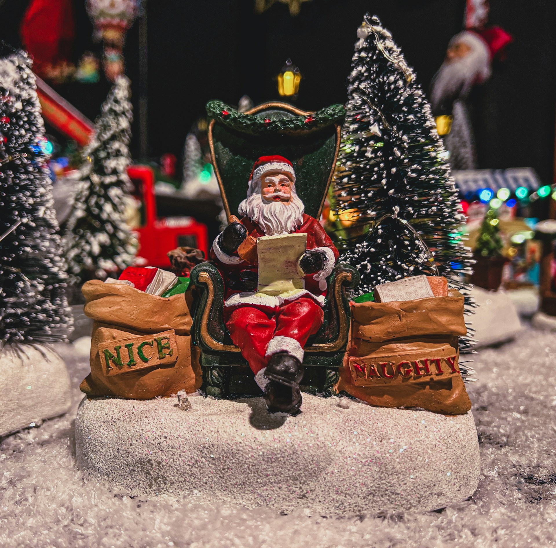 Santa Claus checking his list in a cozy, warmly lit workshop filled with toys and holiday decorations.