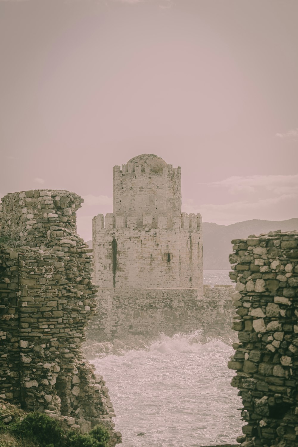 an old castle with a body of water in front of it