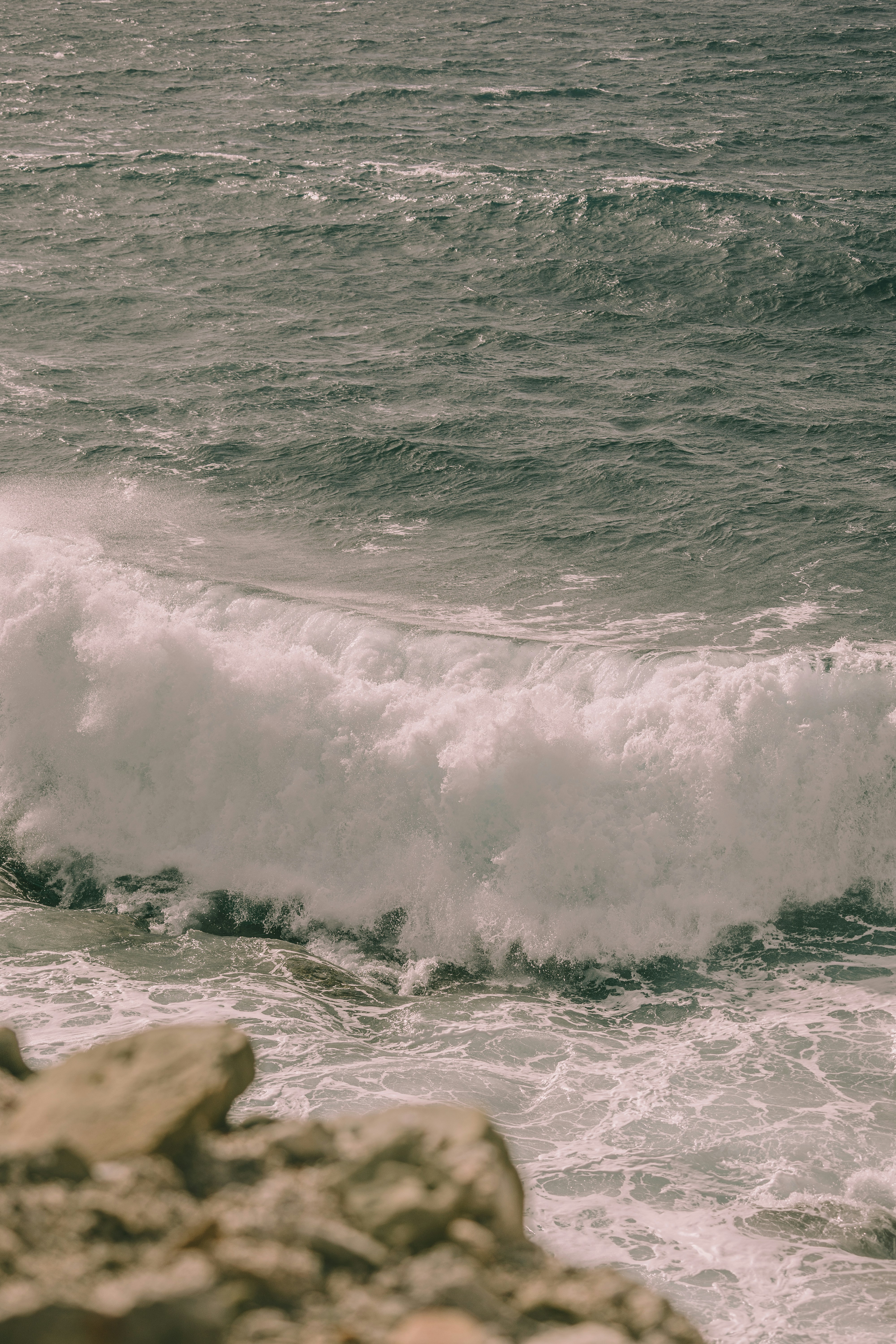 a man riding a surfboard on top of a wave in the ocean