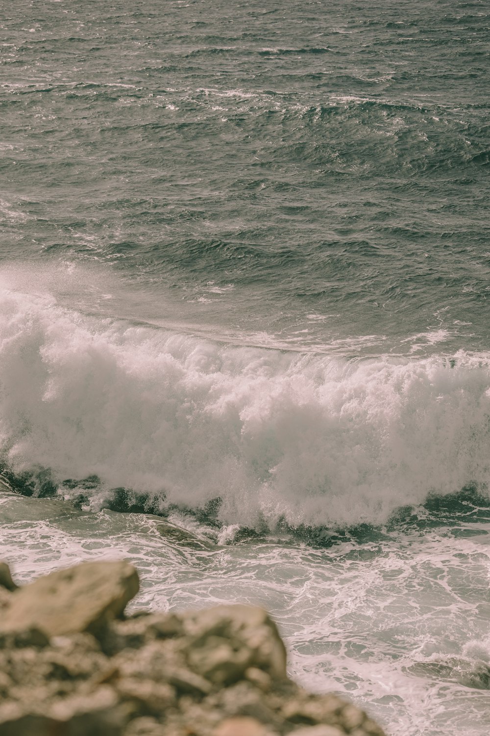 a man riding a surfboard on top of a wave in the ocean