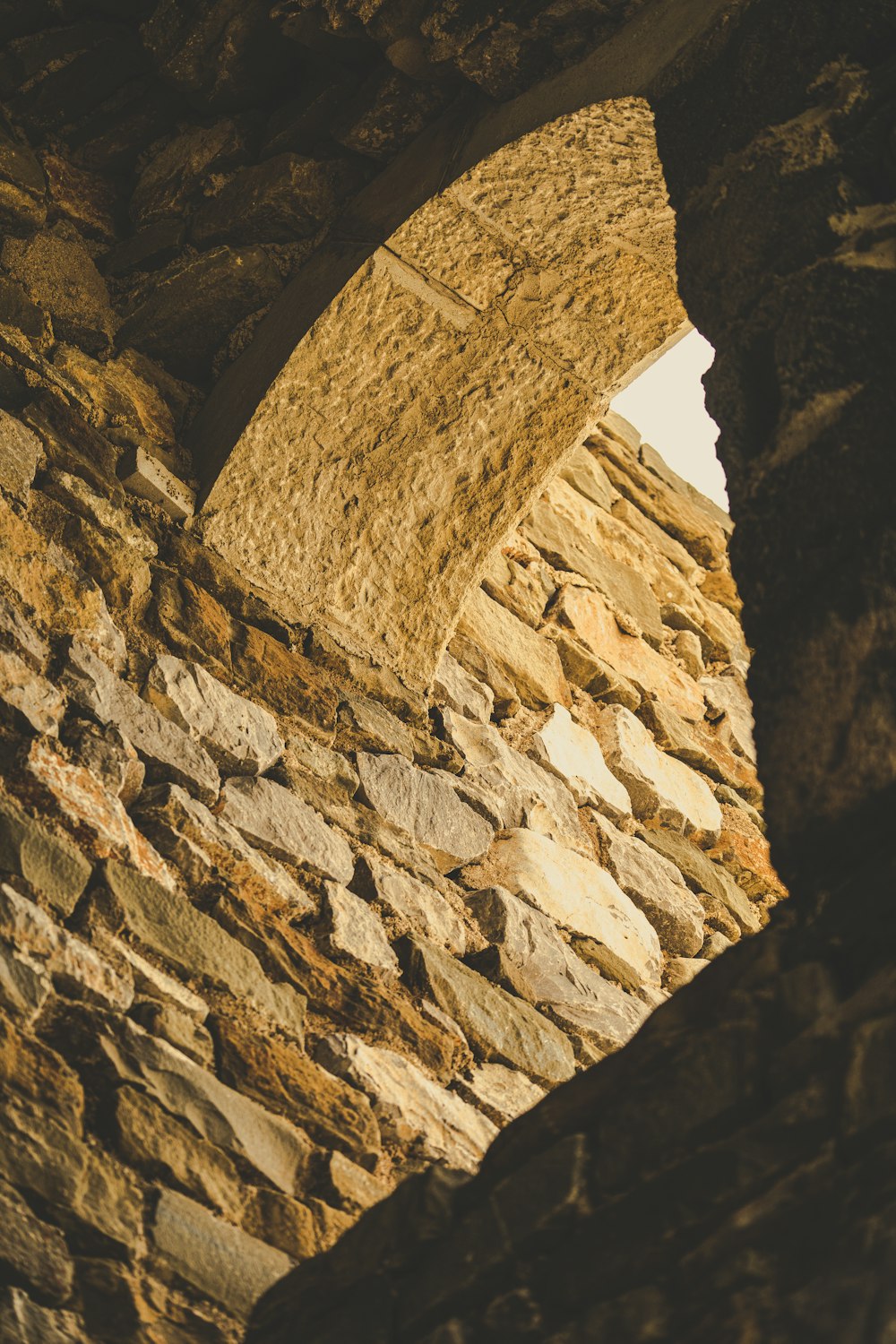 a stone wall with a window in it