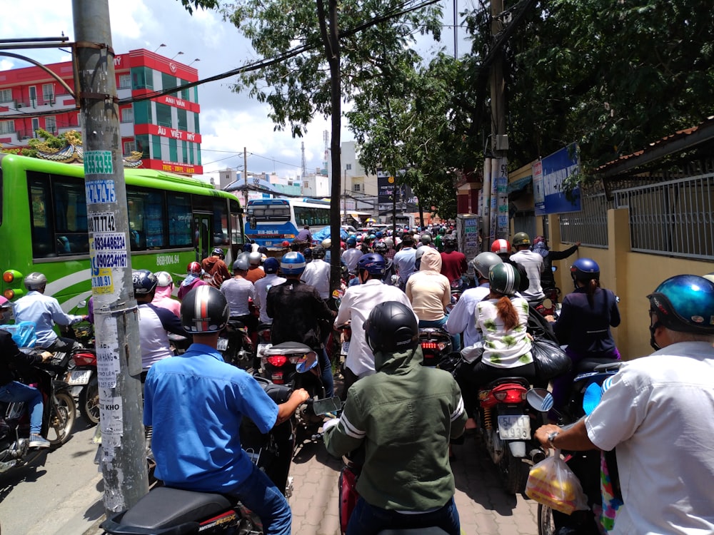 a group of people riding motorcycles down a street