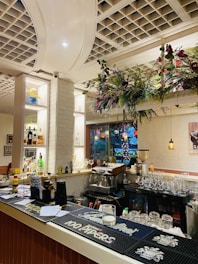 Cozy themed bar with colorful lights and a variety of drinks on display.