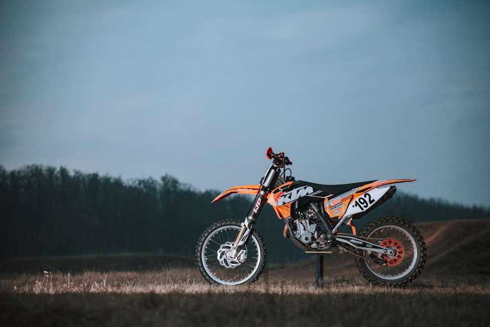 a dirt bike parked on top of a dirt field