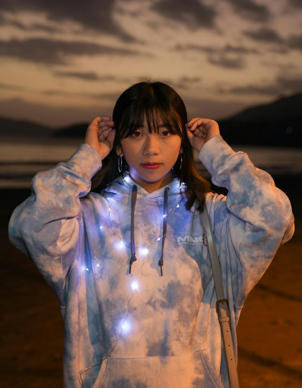 a woman wearing a hoodie with lights on it