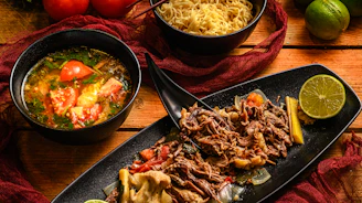 a table topped with bowls of food and bowls of soup