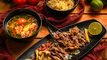 a table topped with bowls of food and bowls of soup