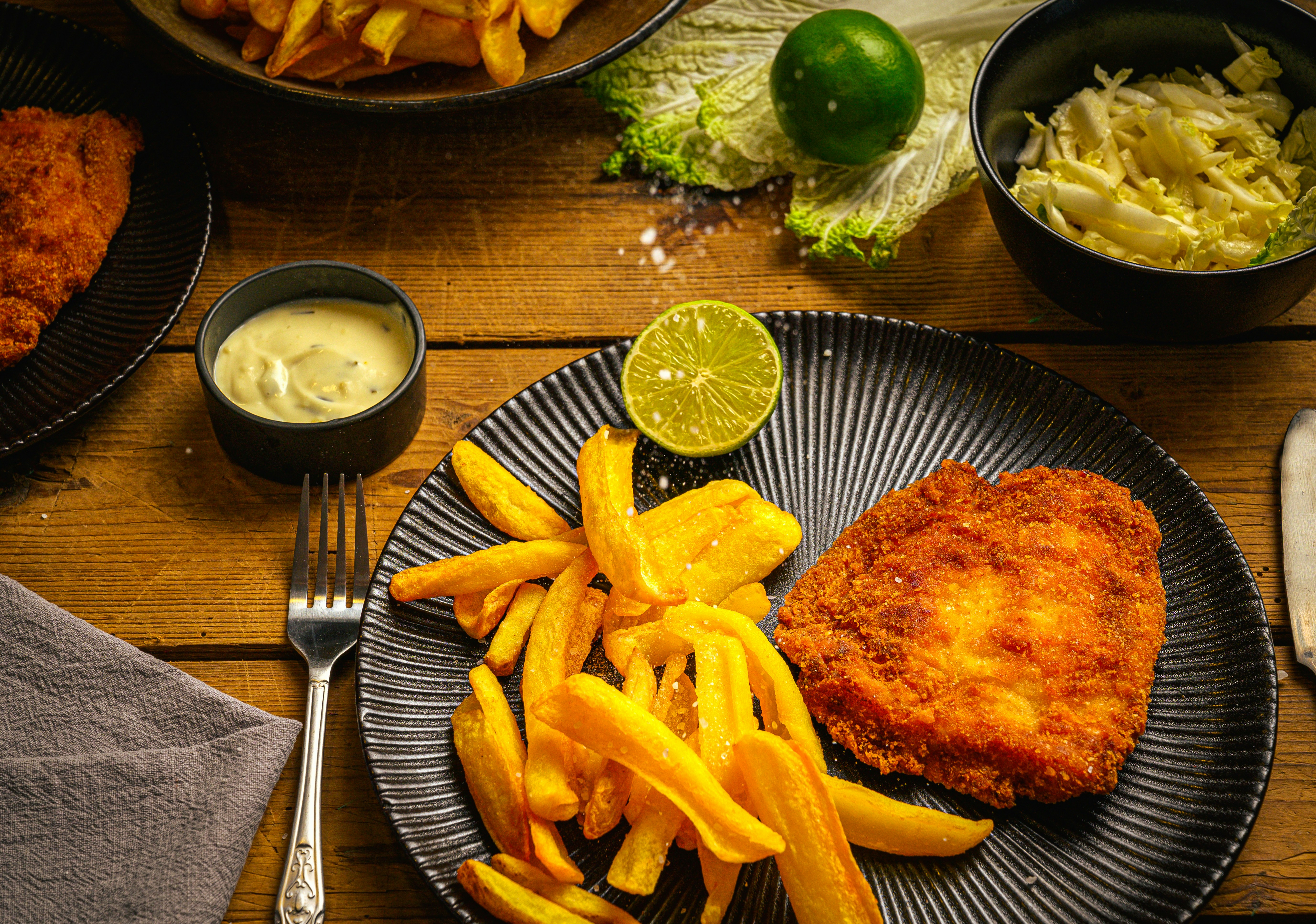 a meal of fried fish, fries, and coleslaw