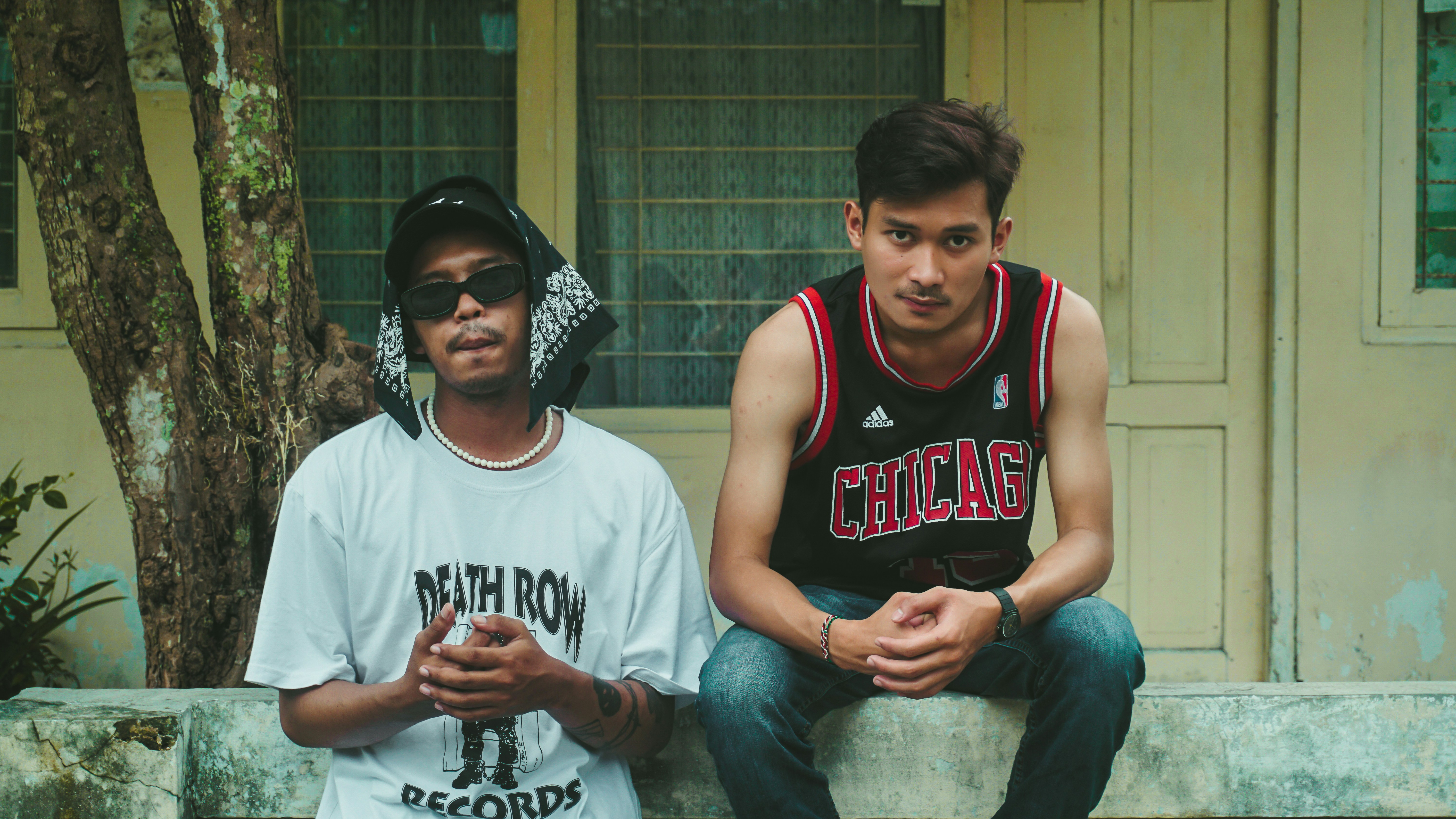 two young men sitting next to each other