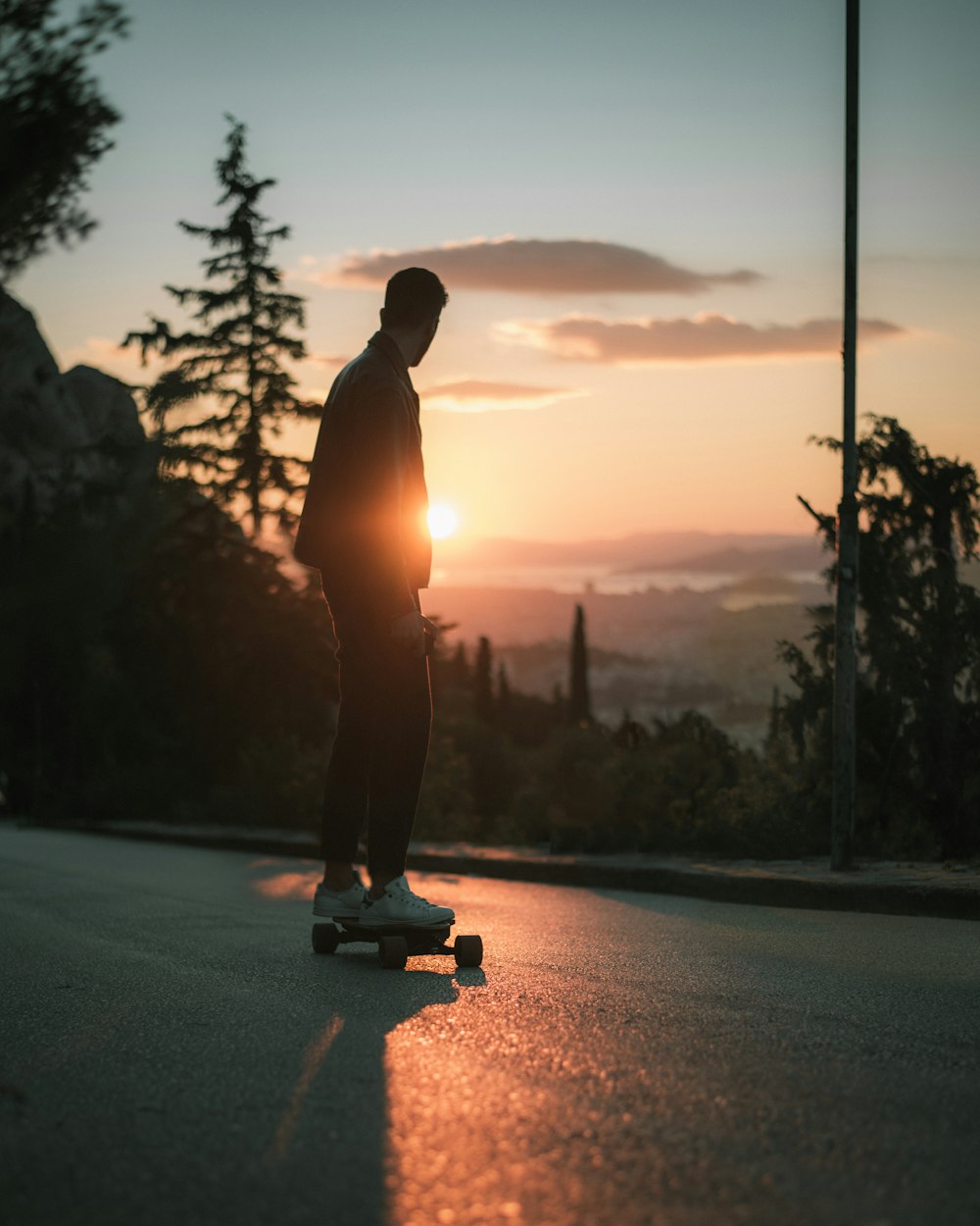 a man riding a skateboard down a street