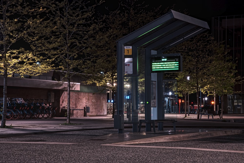 a bus stop on a city street at night