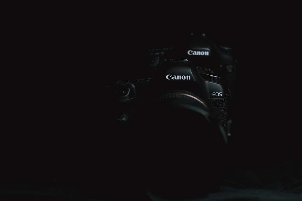 a camera in the dark with a black background